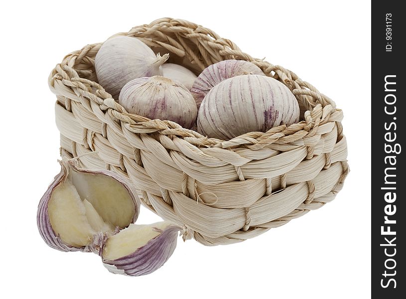 Garlic in little basket, isolated against a white background