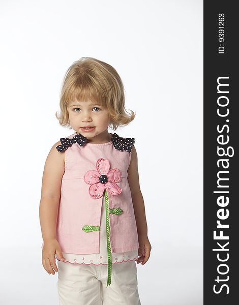 Little girl in pink top with white background