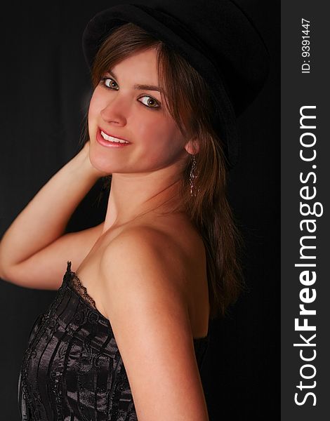 Young beautiful girl in a corset with an hat