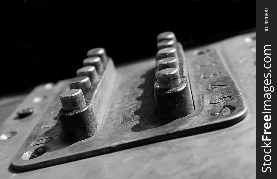 Rusty combination lock on the black background