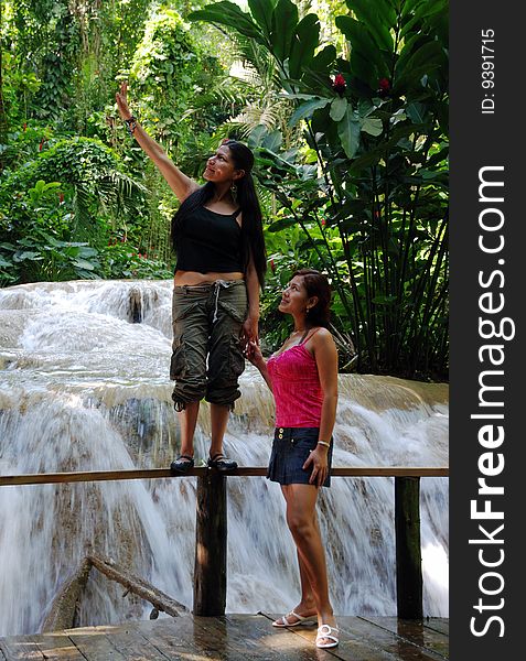 Girls exploring tropical nature in Ocho Rios town garden (Jamaica).
