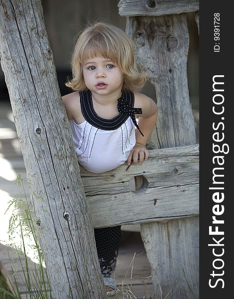 Little girl in barn with white top on. Little girl in barn with white top on