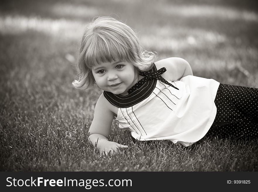 Little girl in grass smiling