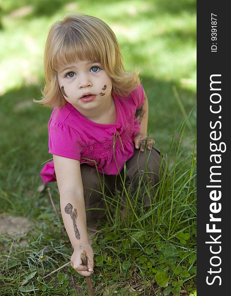 Little girl in pink with muddy face