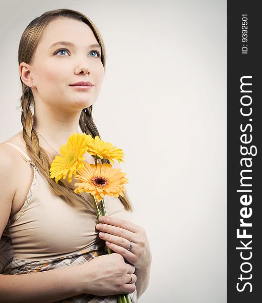Sensual girl with yellow flowers looking up. Sensual girl with yellow flowers looking up