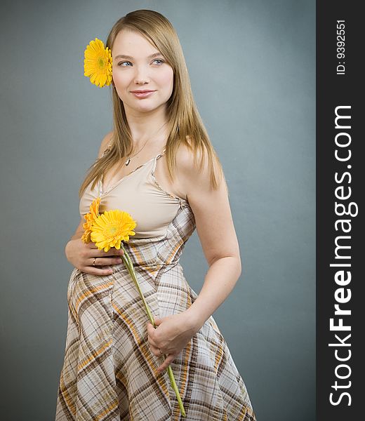 Young pregnant woman with flowers