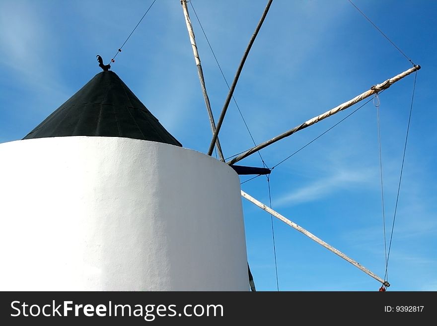 Portuguese functional old windmill close up and blue sky