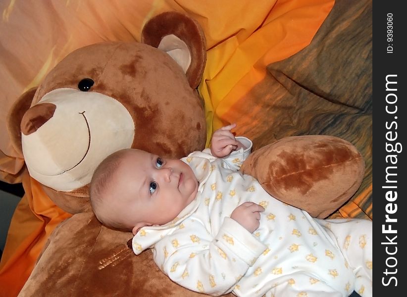 Infant baby boy with big bear toys. Infant baby boy with big bear toys