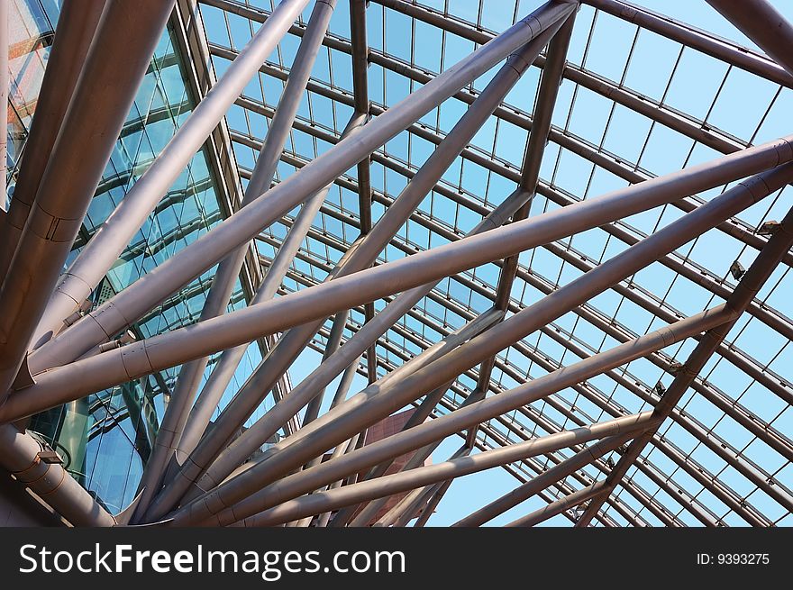 Glass roof of the building over blue sky