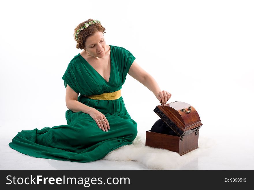 Lady in green antique dress opening box on white background. Lady in green antique dress opening box on white background