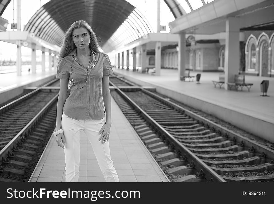 Blond girl outdoors on railway station