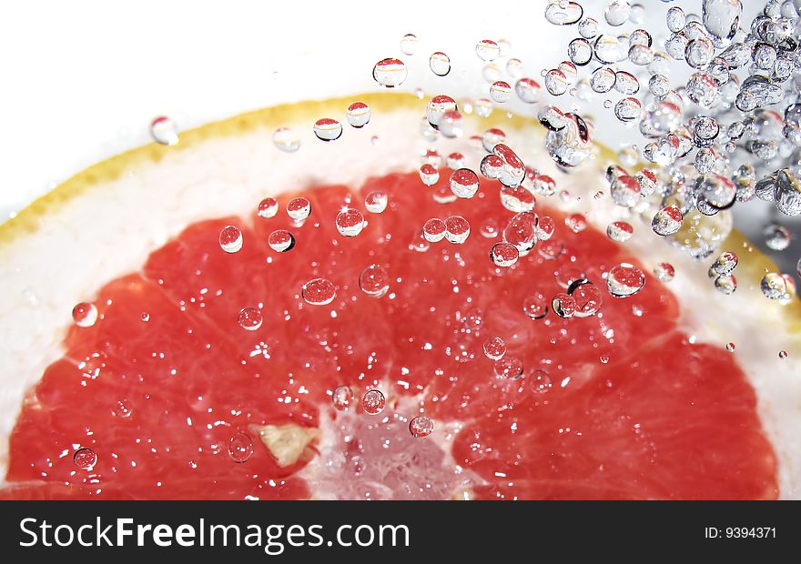 Red grapefruit and splashing water. Red grapefruit and splashing water.