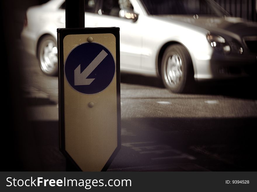 European traffic sign with a luxury sedan in the background