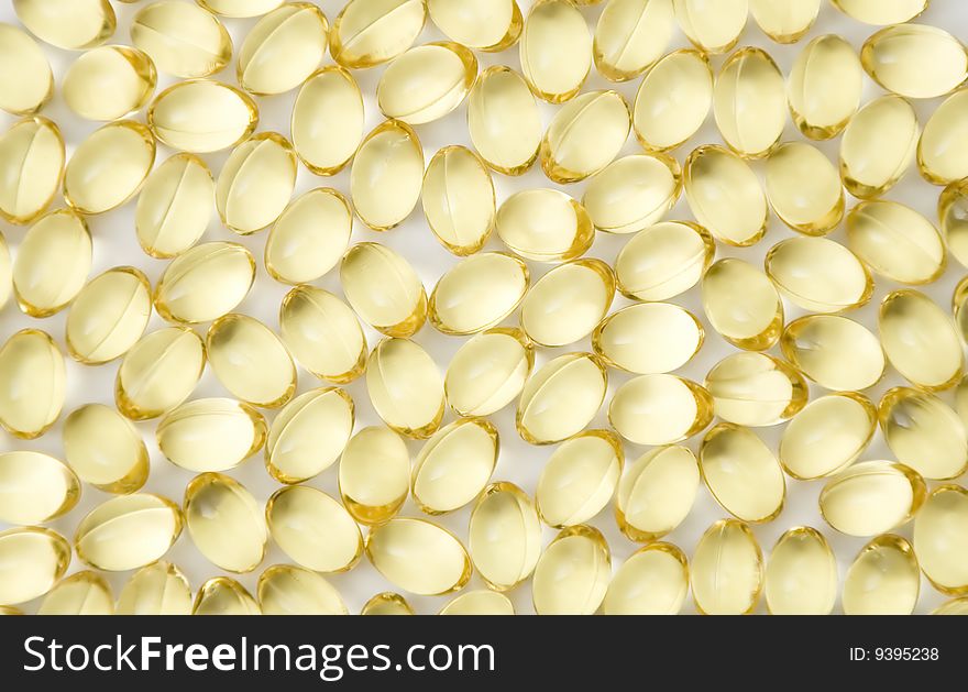 Caplets with fish oil over white background. Caplets with fish oil over white background
