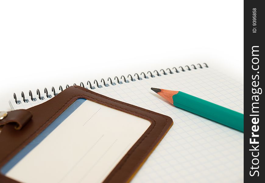 Green pencil rests on the paper. Green pencil rests on the paper