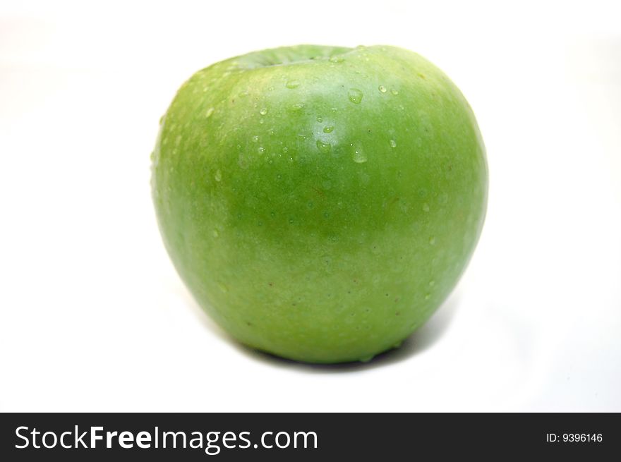Wet green apple on white background