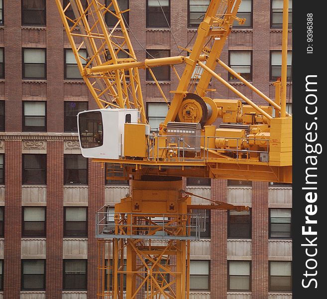 Construction Crane against backdrop of city skyscraper