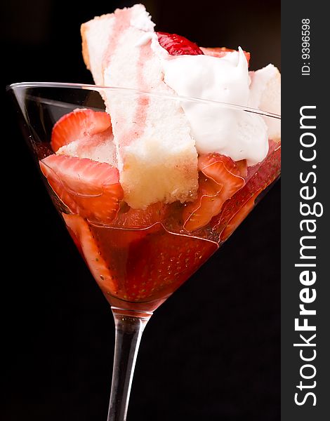 Strawberry shortcake in a martini glass sponge cake and whip cream