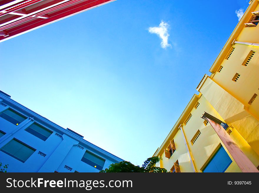 Three walls in differnt colour under the blue sky