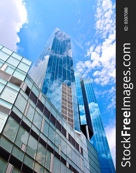 Tall blue building under the bright blue skies