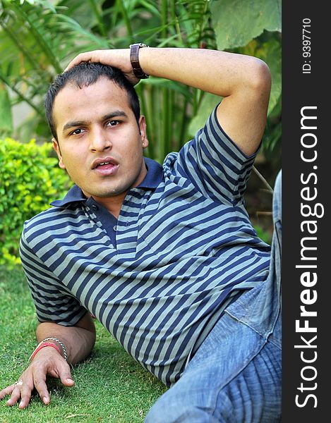 Indian boy sitting in the garden