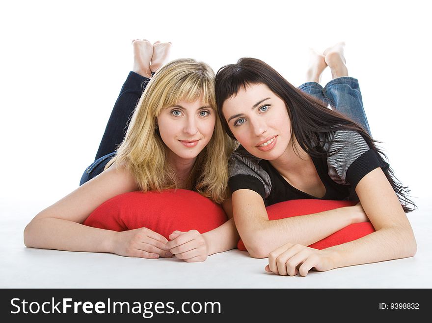 Two beautiful lying girls. Isolated on white background