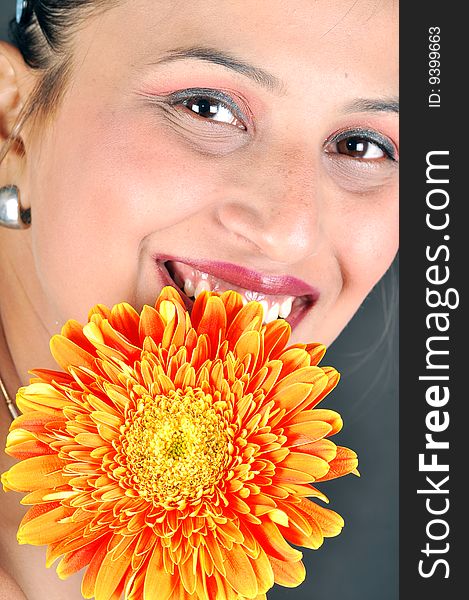 Girl with flower looking beautiful in studio.