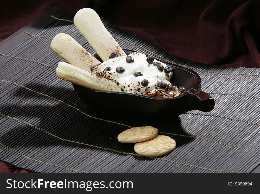 Yoghourt and biscuits isolated on dark background