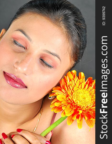 Girl with flower looking beautiful in studio.