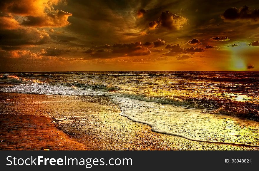 A beautiful sunset is reflected on a beach. A beautiful sunset is reflected on a beach.