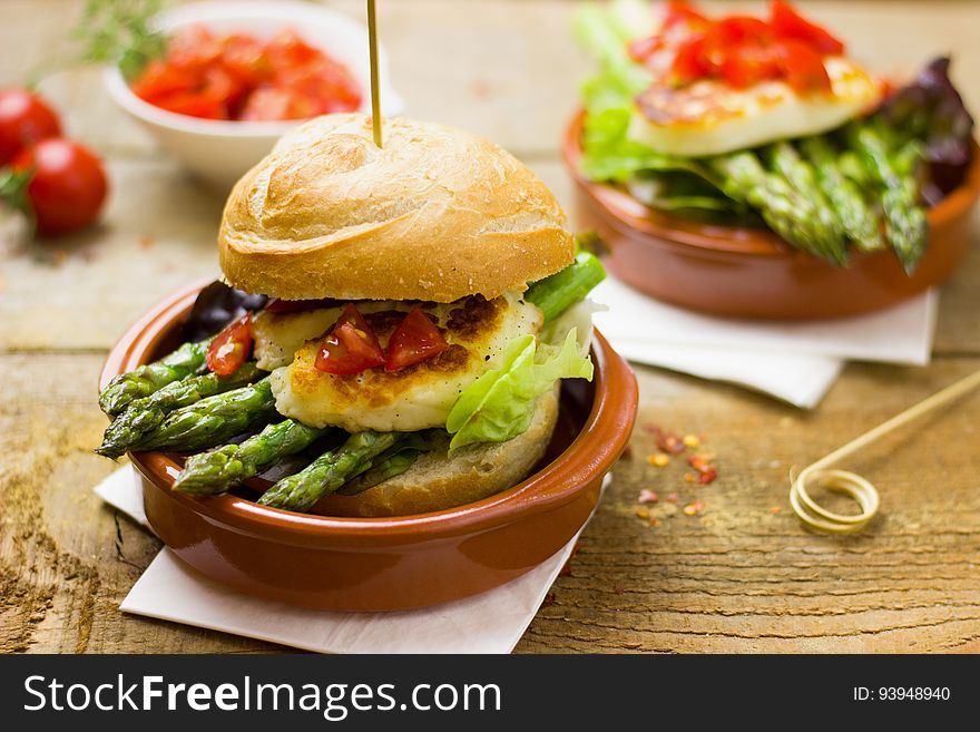 Sandwiches with grilled asparagus and goat cheese in small clay ramekins.