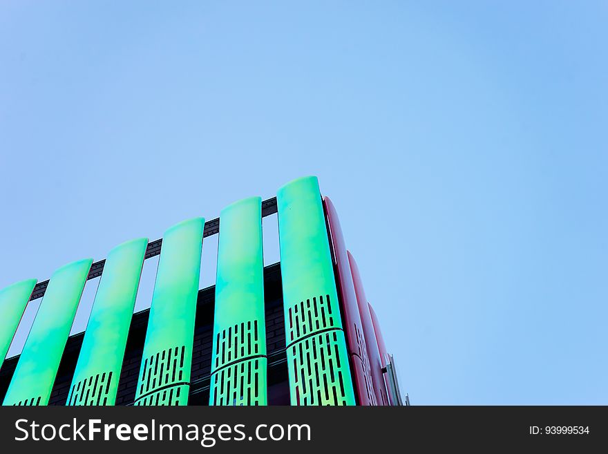 Exterior of modern high rise building against blue skies on sunny day. Exterior of modern high rise building against blue skies on sunny day.