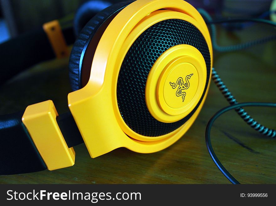 Close up of yellow and black stereo headphone speakers. Close up of yellow and black stereo headphone speakers.