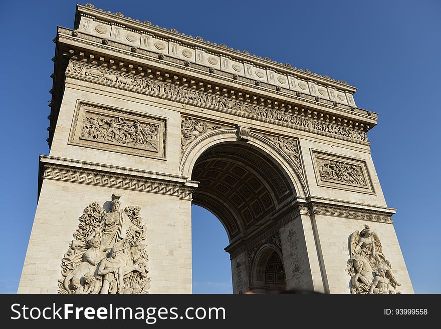Arc de Triomphe in Paris, France against sunny blue skies. Arc de Triomphe in Paris, France against sunny blue skies.
