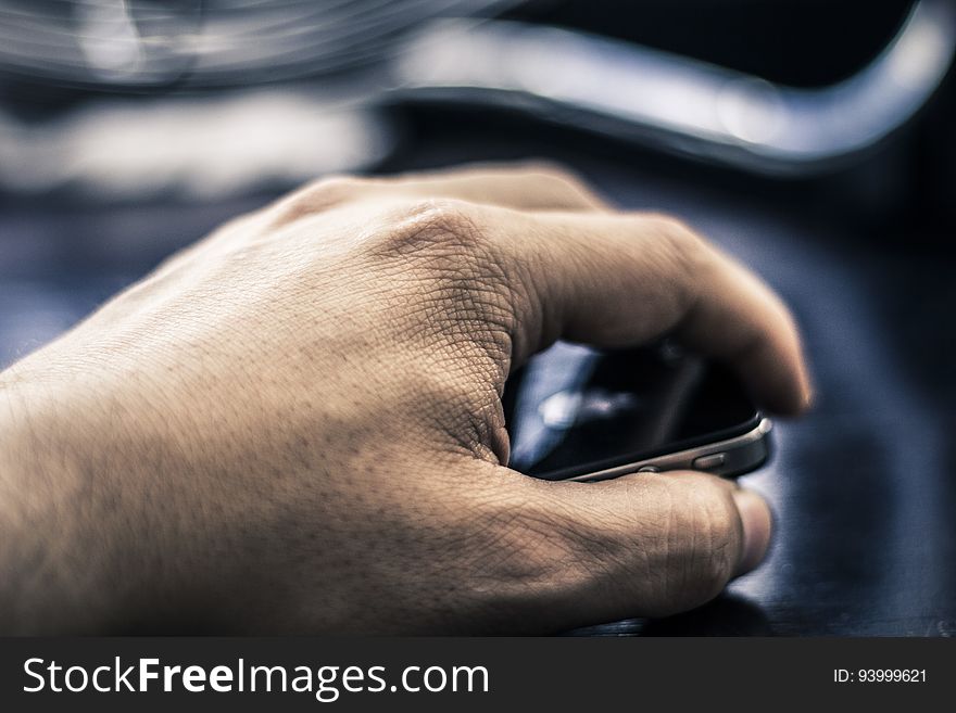 Close up of male hand holding smartphone.