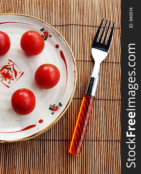 Tomatoes on a plate with a fork