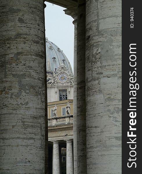 The dome of Basilica San Pietro, St. Peter's Cathedral as seen through the colonnade surrounding Piazza San Pietro, St. Peter's square in Rome. The dome of Basilica San Pietro, St. Peter's Cathedral as seen through the colonnade surrounding Piazza San Pietro, St. Peter's square in Rome