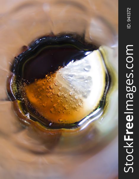 Close up from above of a glass of coke and lemon