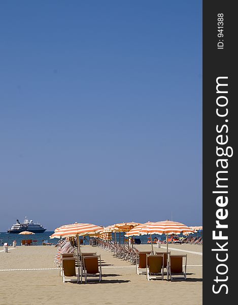 A beach in Italy with a big yacht in the background. A beach in Italy with a big yacht in the background