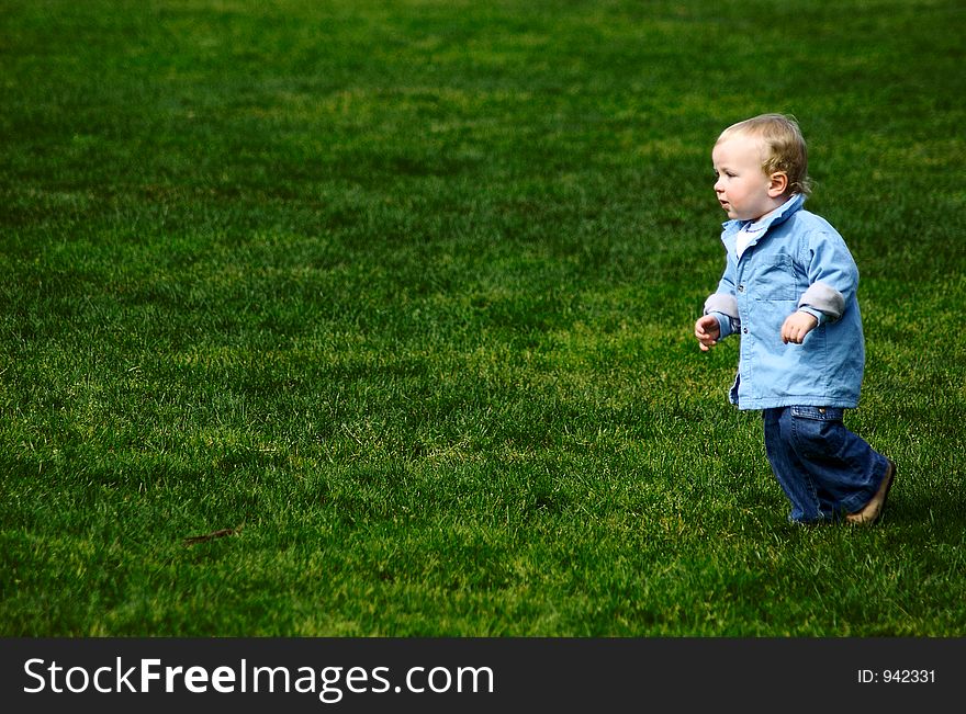 Toddler Running on Green Grass