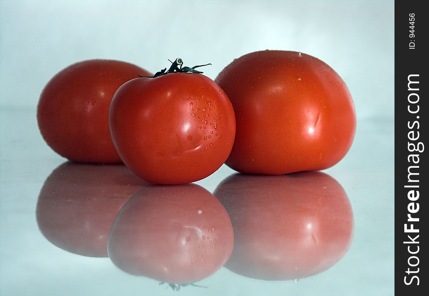 Three wet tomatoes. Three wet tomatoes