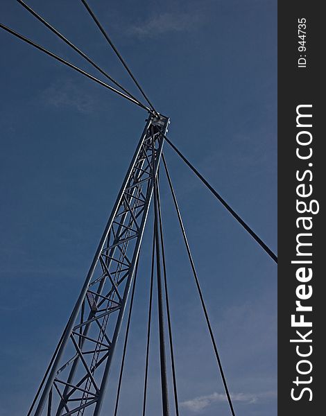 Abstract of steel suspension bridge support cables and pylon in front of blue sky