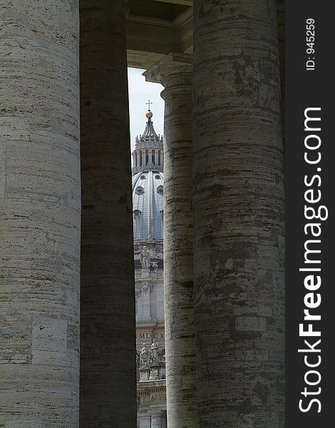 St. Peter's Cathedral, Basilica San Pietro, seen through the colonade at the Vatican in Rome, Italy. St. Peter's Cathedral, Basilica San Pietro, seen through the colonade at the Vatican in Rome, Italy