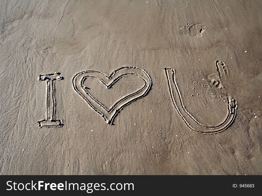 Printed words 'I love you' on sand. Printed words 'I love you' on sand