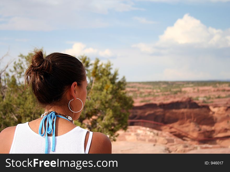 A beautiful young native American woman gazing at the southwestern landscape. A beautiful young native American woman gazing at the southwestern landscape