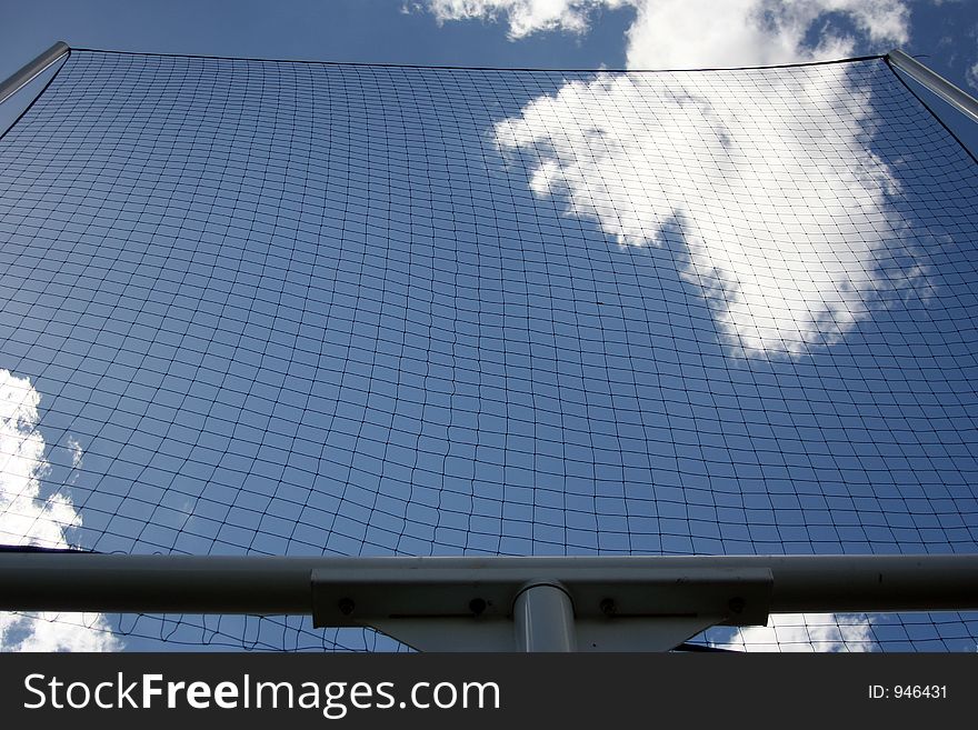 View of the sky through a football goal net.