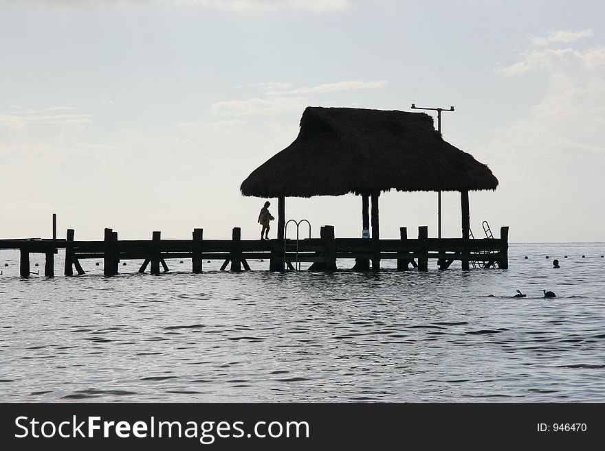 Silhouette of a persone walking on a pier. Silhouette of a persone walking on a pier