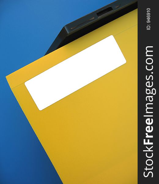 A yellow folder sitting on an office tray. Add your own word on the white label. A yellow folder sitting on an office tray. Add your own word on the white label.