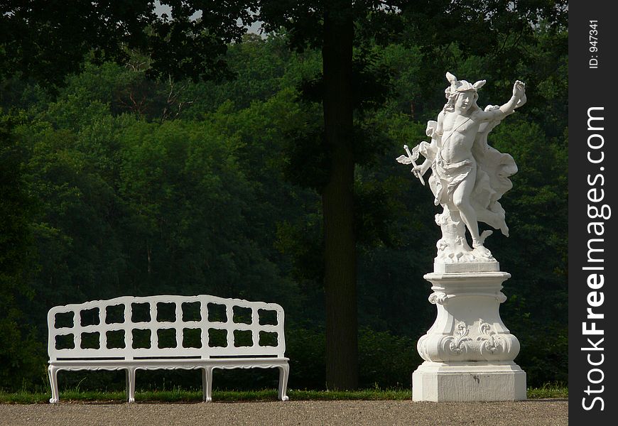 Baroque statue and bench in a german castle garden