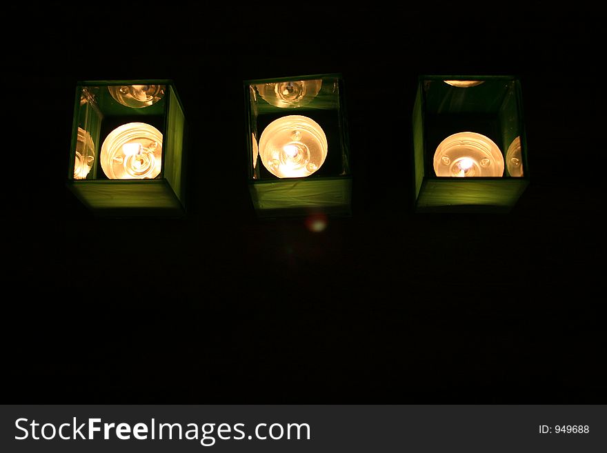 Three tealight candles in home-made glass candle holders. Three tealight candles in home-made glass candle holders